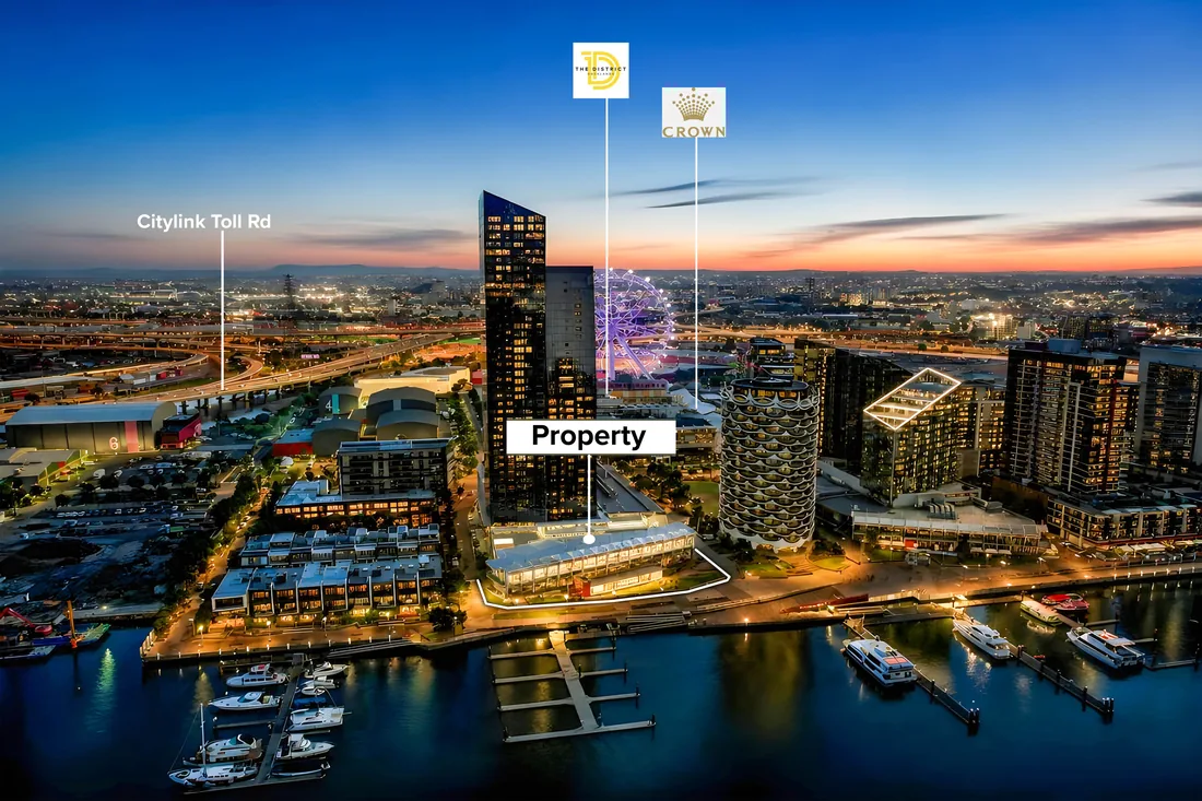 Dusk aerial of a Docklands waterfront commercial tower in Melbourne, the subject property marked against the marina and CityLink