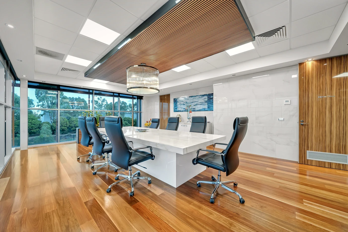 Executive boardroom with a timber-battened ceiling, floor-to-ceiling glazing and polished timber floor — a commercial office fit-out photographed by Sixth Vision