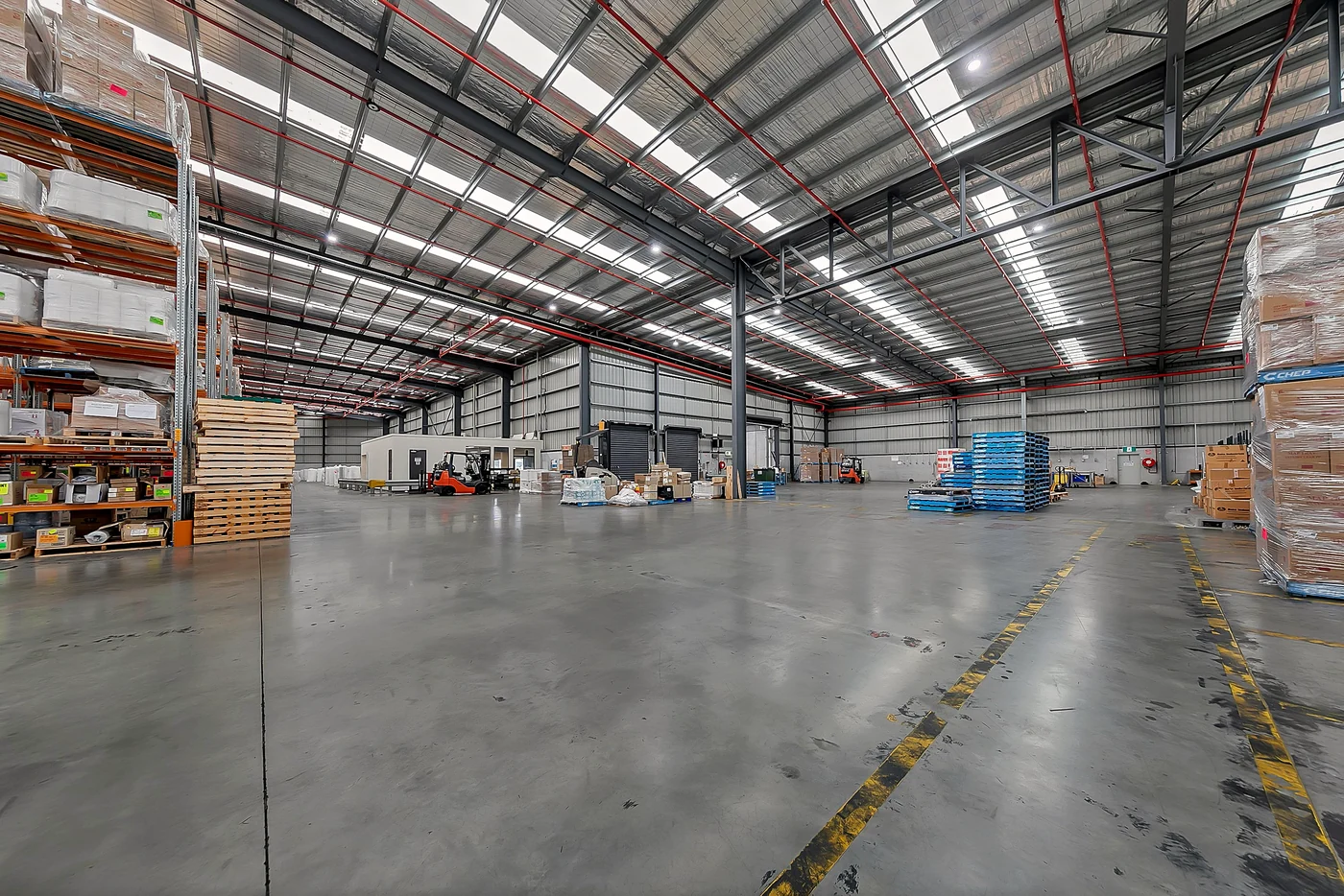 Commercial and industrial real estate photography Melbourne — high-bay pallet racking inside a clear-span warehouse