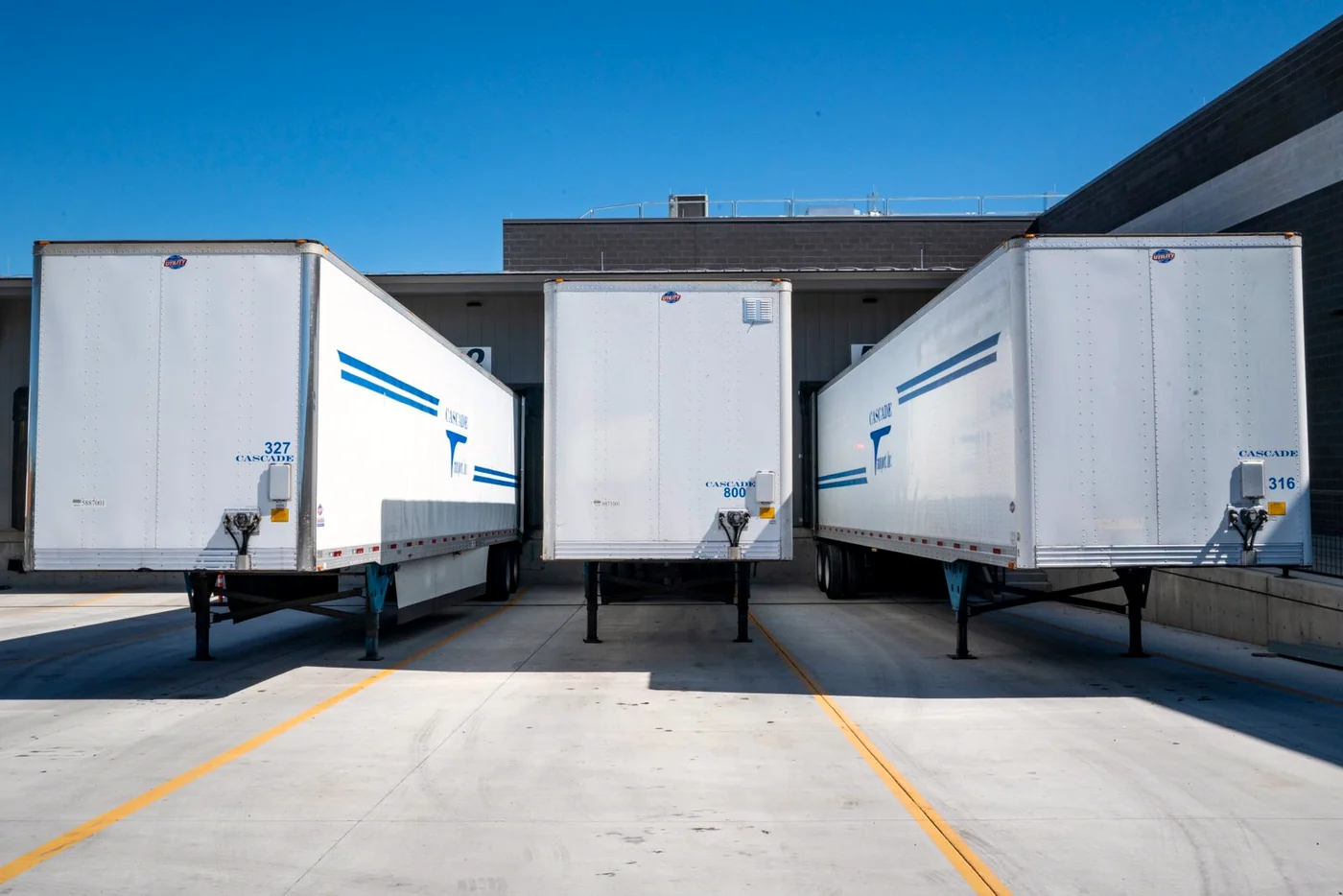 Commercial and industrial real estate photography Melbourne — freight trailers backed onto a distribution centre loading dock